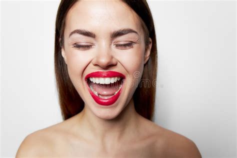 emotional woman with open mouth holding her head bare shoulders stock