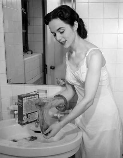 Woman Washing Her Hose At Bathroom Sink Circa 1950s Photo 5719300