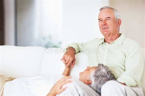 relaxed mature couple on sofa portrait of happy mature couple relaxing
