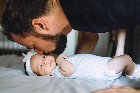 Father Kissing His Newborn Daughter By Tanya Yatsenko Stocksy United