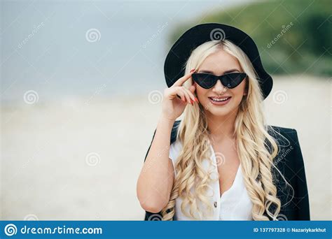 Cute Blonde Girl In Glasses Walks Along The Coast And Enjoy Life Stock