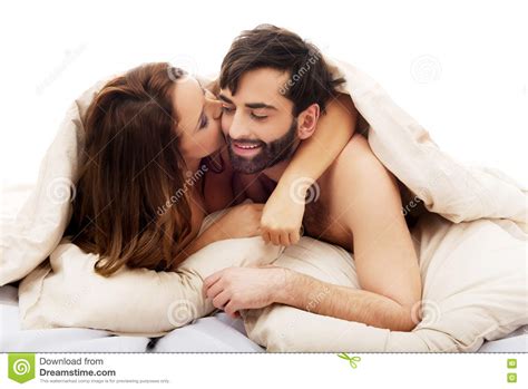 Beautiful Couple Under The Cover In Their Bed Stock Image