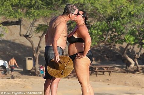 loved up pierce brosnan kisses his wife on hawaiian beach daily mail online