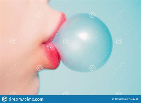 Female Lips Blowing Bubble Gum Close Up Of A Woman Face