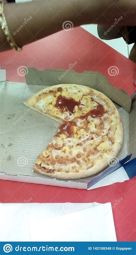 three fourth of delivered pizza with some red sause remaining on the