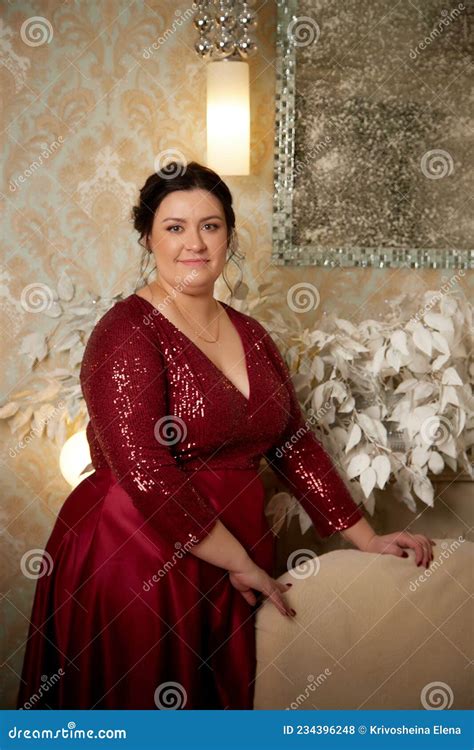 a beautiful majestic solemn fat queen in a red elegant dress in a
