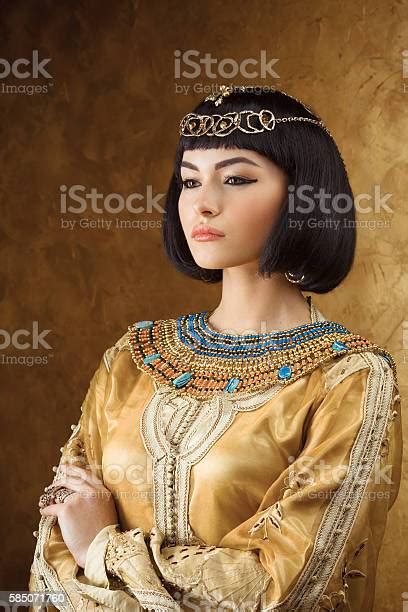 beautiful egyptian woman like cleopatra on golden background stock
