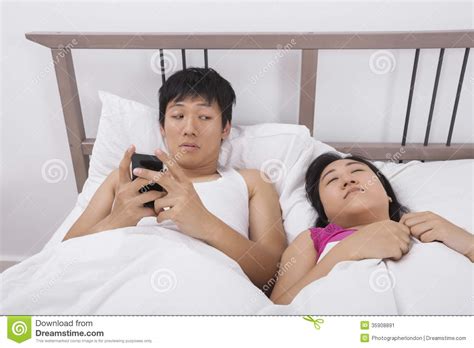 Two Asian Women Using Cell Phone Stock Image