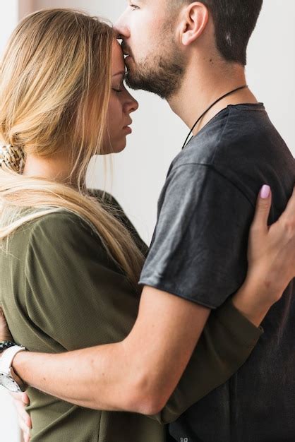 Free Photo Affectionate Young Male Kissing Her Girlfriend On Forehead