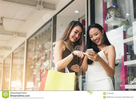 teenager asian woman standing at store front with happy