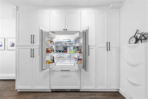 tall kitchen pantry cabinets create  full wall effect sweeten