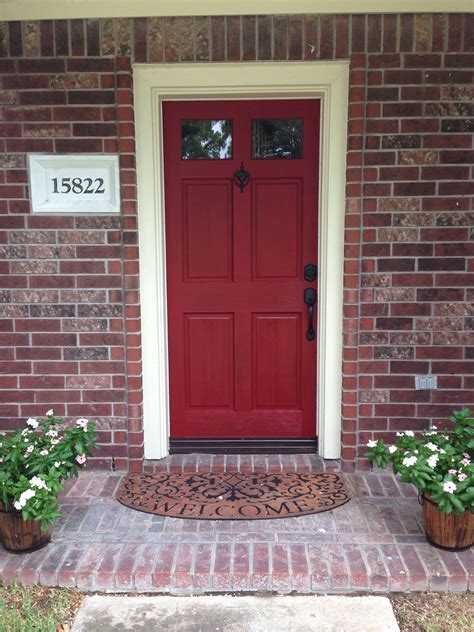 red front door   planters   side   brick walkway