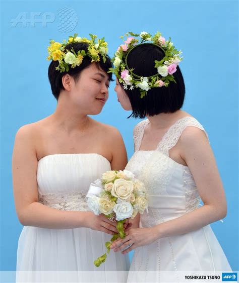 Japan Tokyo A Lesbian Couple Kiss As They Pose For Photos Taken By A
