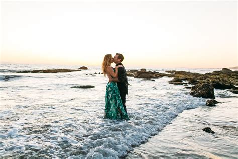 Romantic Couple Playing In The Ocean In Laguna Beach For Engagement