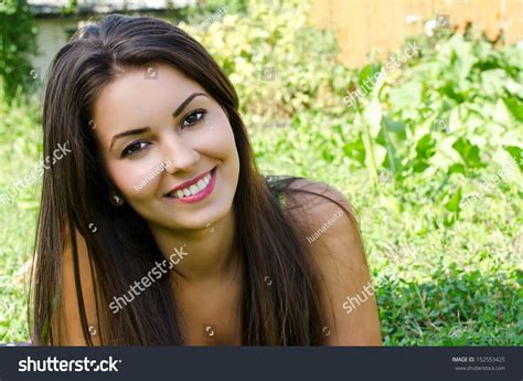Girl Smiling Lying On The Grass Portrait Of A Beautiful