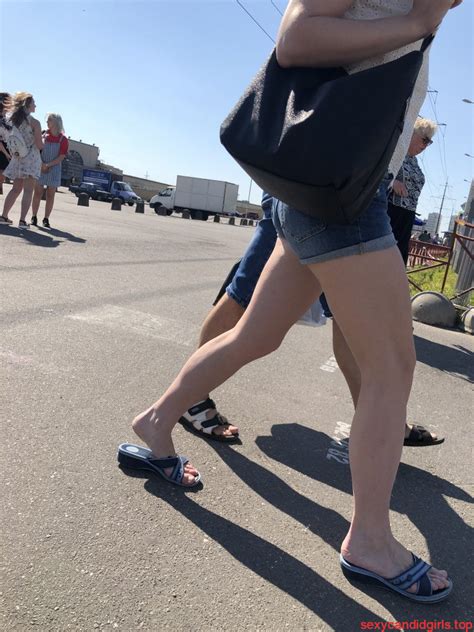 hot pale legs in denim mini shorts on the crosswalk street