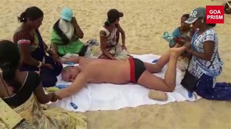 An Open Air Body Massage Of A Tourist By Six Ladies On A