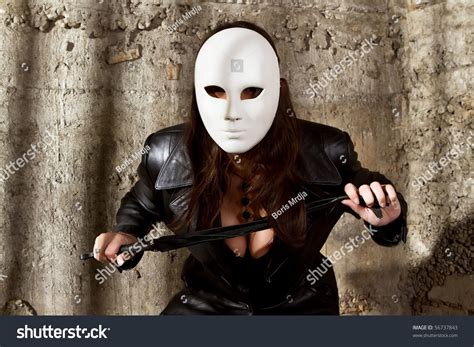 dominatrix wearing black leather white carnival stock