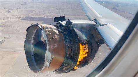 watch passenger records plane engine catching fire as debris falls to