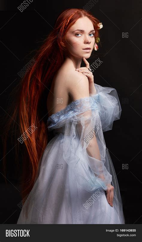 sexy beautiful redhead girl with long hair in dress cotton retro woman portrait on black