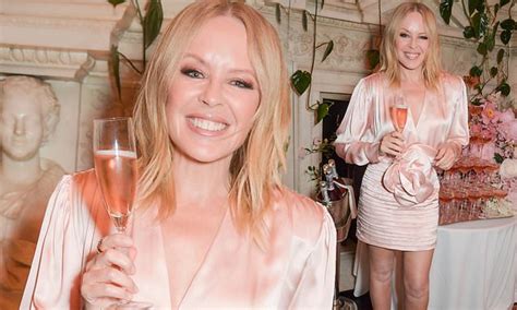 kylie minogue 54 shows off her youthful looks in a blush satin gown