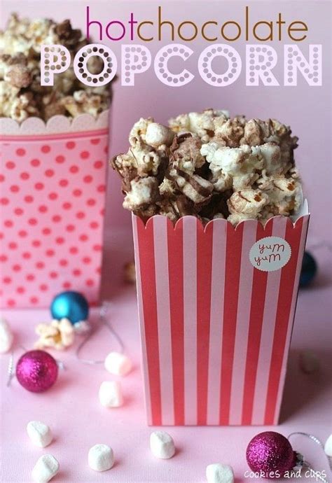 Two Pink Boxes Filled With Popcorn On Top Of A Table