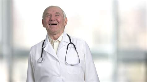 doctor laughing  putting hands  aged friendly physician