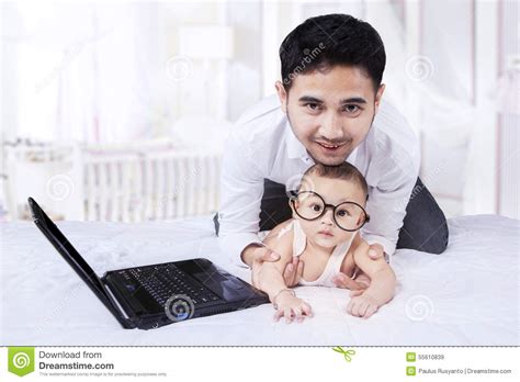 Cute Infant Wearing Round Glasses On Bed Stock Image