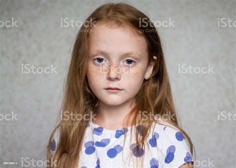 little beautiful redhaired girl with freckles looking seriously stock