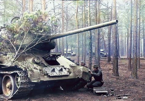 The Crew Of The T 34 85 Repairs Its Combat Vehicle During The March