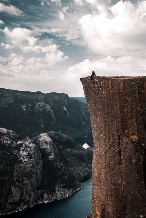 people sitting   edge   cliff  stock photo