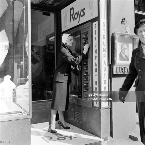 a woman buying a new pair of nylons from a stocking vending machine