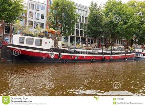 traditional house boat on the canals of amsterdam