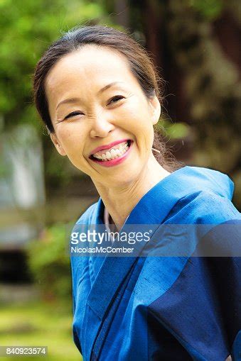 Mature Japanese Woman In Blue Kimono Smiling Widely High Res Stock