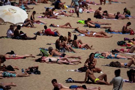 People Sunbathe In A Beach In Barcelona Spain Friday May 15