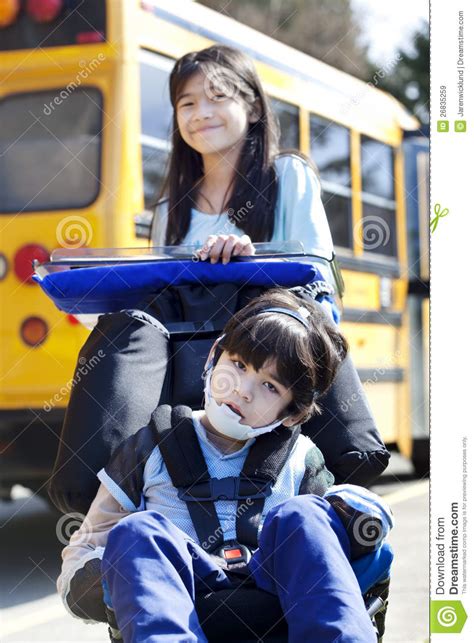 sister pushing disabled brother in wheelchair royalty free stock images image 26835259