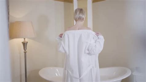 Young Blond Slim Woman Undressing In Bathroom Back View Of Caucasian