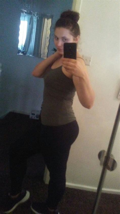 A Woman Taking A Selfie In Front Of A Mirror While Wearing Leggings