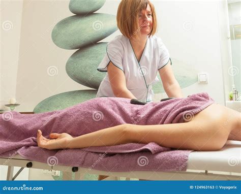 Female Masseuse Doing Massage With Hot Stones Stock Image Image Of