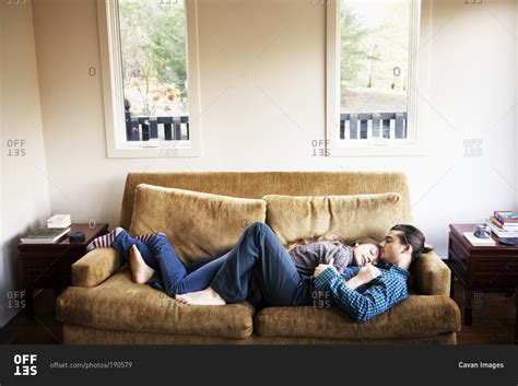 couple cuddling  sleeping  couch  stock photo offset