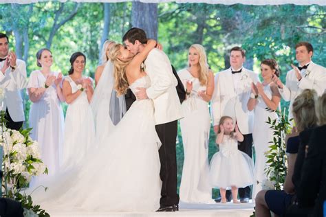 wedding party celebrating couple s first kiss at ceremony