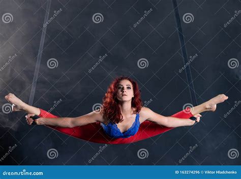 female athletic and flexible aerial circus artist with redhead on