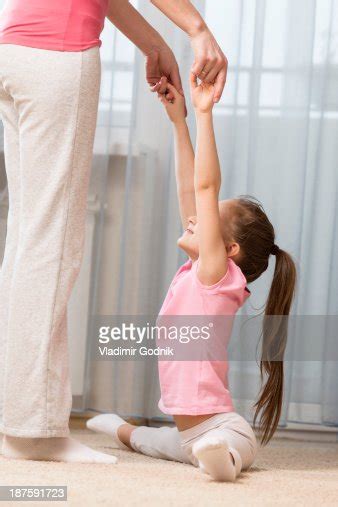 Girl Doing The Splits With A Little Help From Her Mother Photo Getty