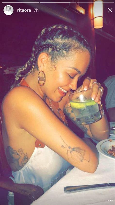 rita ora shows off glowing tan and thigh tattoo in white bikini as she continues to share