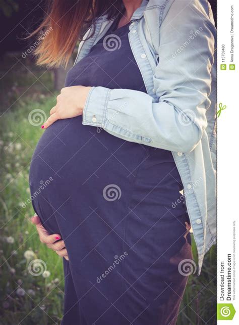 pregnant woman touching her belly with care pregnancy maternity and