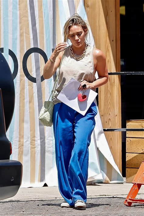 hilary duff looks fab in a white tank top and blue trousers while out