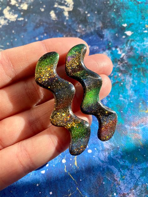 wiggly space noodle stud earrings  colorshifting glitter etsy
