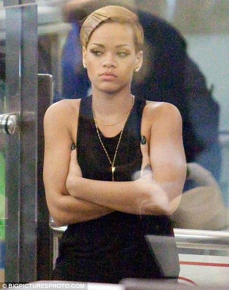 rihanna sulks as she s frisked by security guard at la airport daily