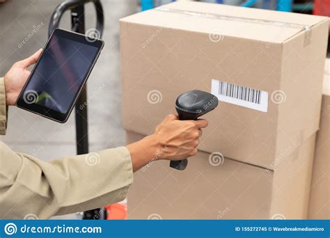 female worker scanning package  barcode scanner   digital tablet  warehouse