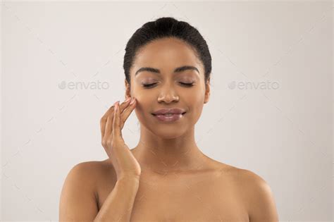 Sensual Attractive Topless Young Black Woman Enjoying Smooth Facial